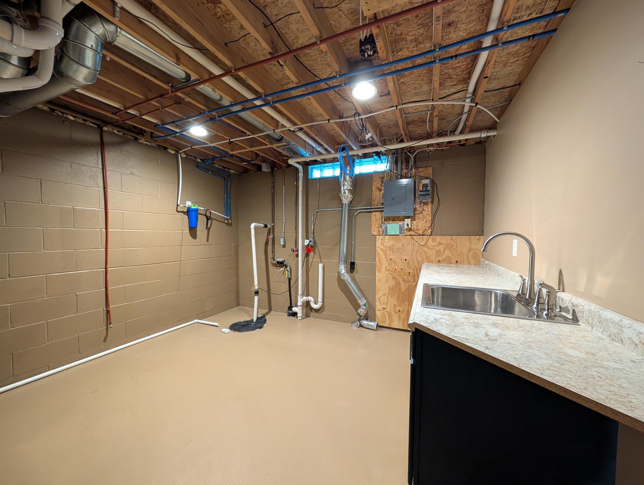 Yet another pristine space, the combined mechanical/laundry space features full sink, lots of counter space, washer and dryer hookups.