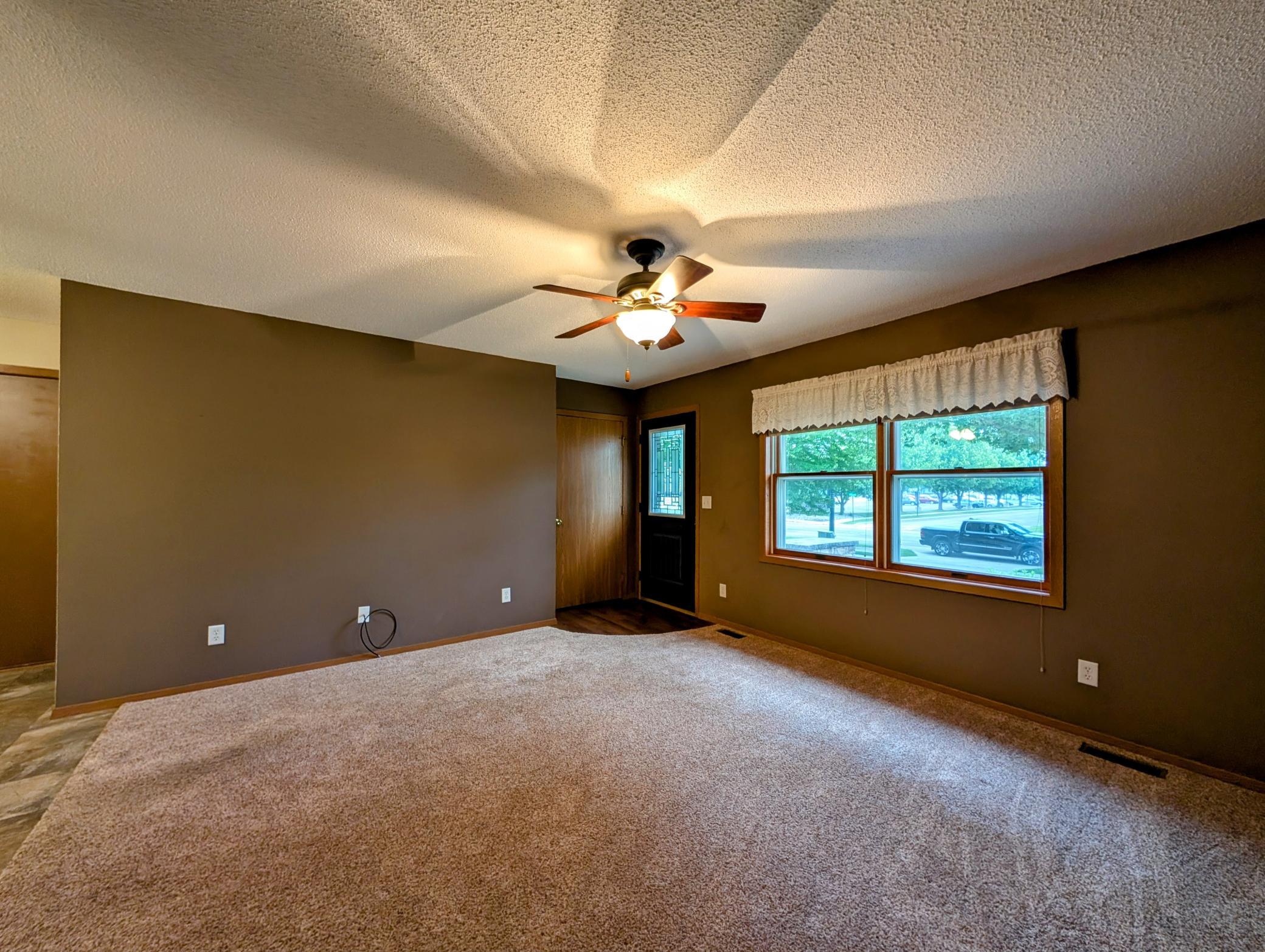 Plush carpeting over thick pad in the spacious front living room is nearly new.