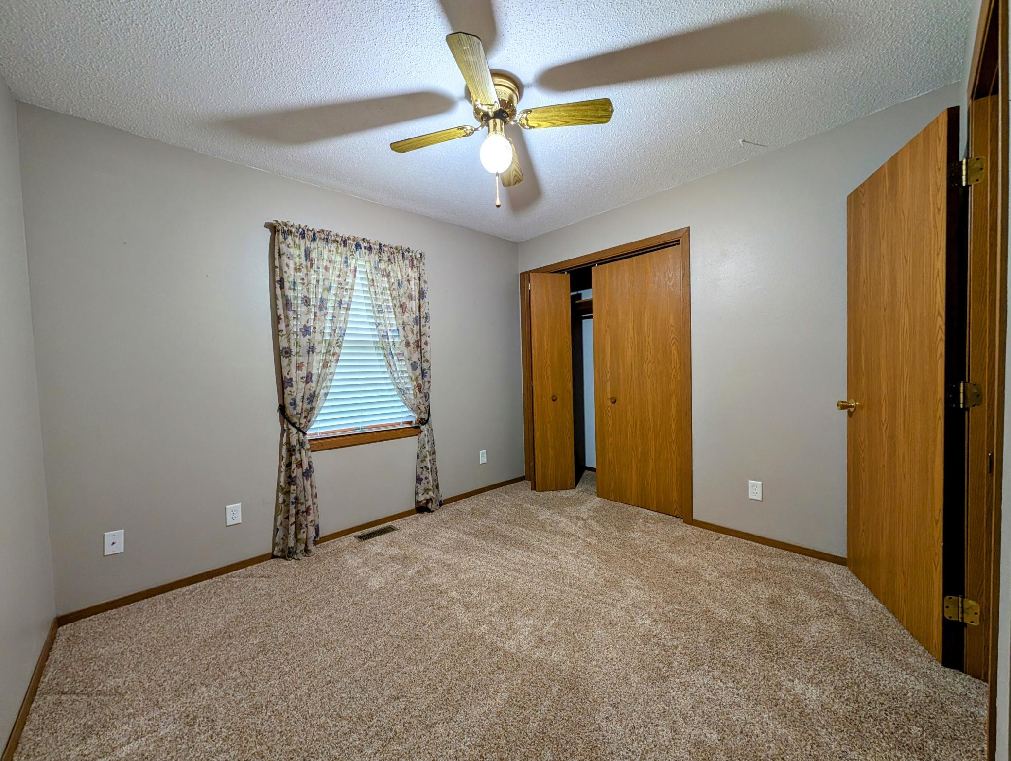 BR #2 enjoys view of serene back yard, features spacious closet.