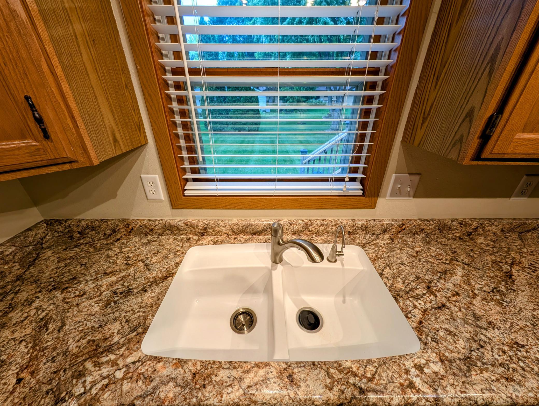 Undermount sink is another nice upgrade, window looks over serene back yard.