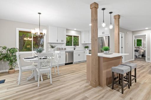 The kitchen has been fully upgraded with brand-new cabinets, stylish hardware, a modern backsplash, hood vent, and sleek stainless steel appliances.