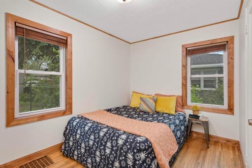 Bedroom 1 of 2 is located in the rear of the home.