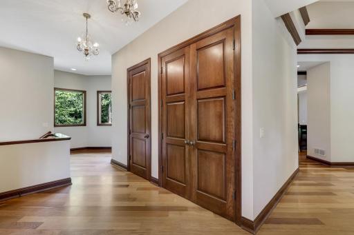 The generously sized mudroom boasts abundant closet storage, a private front entrance, and access to the lower level and garage.