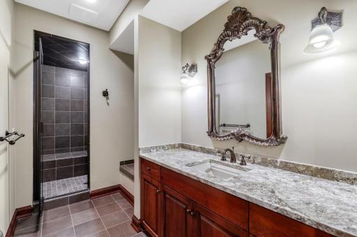 The first of three lower-level bathrooms. This bathroom serves the common areas and doubles as a pool bathroom / shower.
