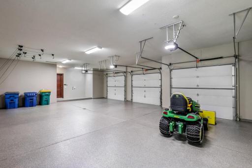 The large, fully finished and heated, 3-car garage boasts newly epoxied floors, space for supplemental storage, 1 EV charger and wiring for a 2nd EV charger.