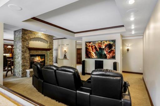 The theater features a large screen, built in speakers and motorized blackout shades.