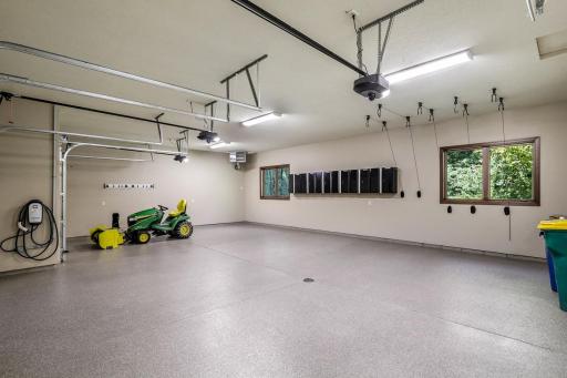 The large, fully finished and heated, 3-car garage boasts newly epoxied floors, space for supplemental storage, 1 EV charger and wiring for a 2nd EV charger.