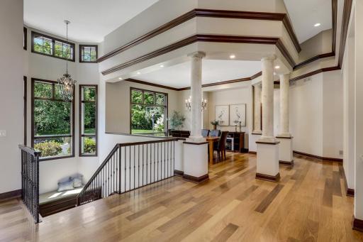 Elegant columns surround the formal dining room which is open and bright with a large picture window.