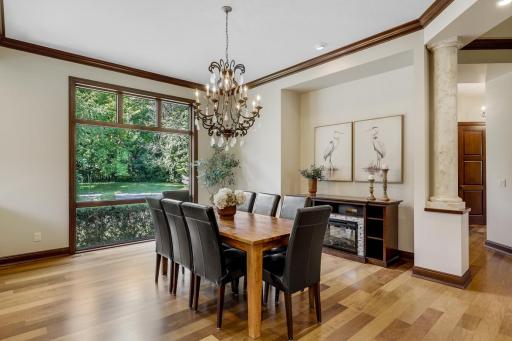 Elegant columns surround the formal dining room which is open and bright with a large picture window.