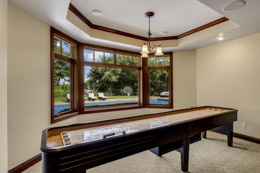 The theater features a large screen, built in speakers and motorized blackout shades.