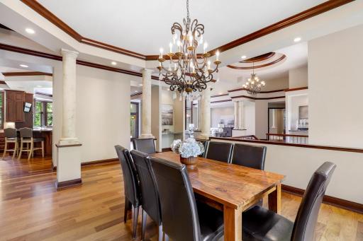 Elegant columns surround the formal dining room which is open and bright with a large picture window.