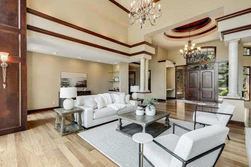 The living room is mostly open to the kitchen and dining room, features a gas fireplace and a magnificent, arched picture window which invites natural light to fill the space.