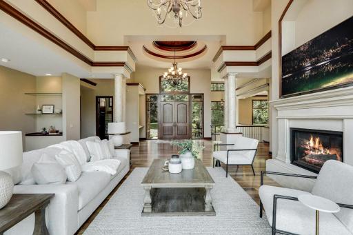 The living room is mostly open to the kitchen and dining room, features a gas fireplace and a magnificent, arched picture window which invites natural light to fill the space.