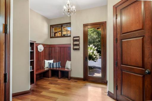 The generously sized mudroom boasts abundant closet storage, a private front entrance, and access to the lower level and garage.