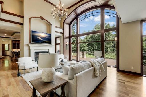 The living room is mostly open to the kitchen and dining room, features a gas fireplace and a magnificent, arched picture window which invites natural light to fill the space.