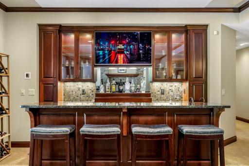 The entertaining common space includes a billiard room with a full bar which boasts a sink, beverage fridge, ice maker and a built-in microwave.