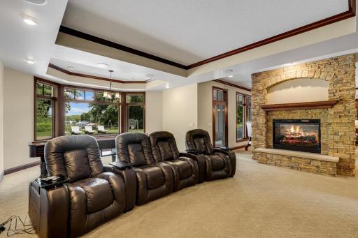 The theater features a large screen, built in speakers and motorized blackout shades.