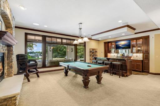 The lower level carries forward the walls of windows, high ceilings, and deluxe finishes so that it almost feels like the main floor.