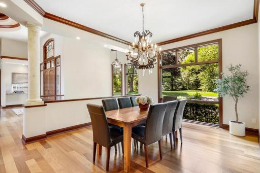 Elegant columns surround the formal dining room which is open and bright with a large picture window.