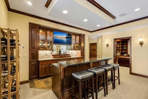 The entertaining common space includes a billiard room with a full bar which boasts a sink, beverage fridge, ice maker and a built-in microwave.