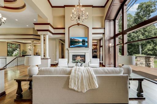 The living room is mostly open to the kitchen and dining room, features a gas fireplace and a magnificent, arched picture window which invites natural light to fill the space.