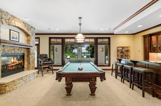 The entertaining common space includes a billiard room with a full bar which boasts a sink, beverage fridge, ice maker and a built-in microwave.