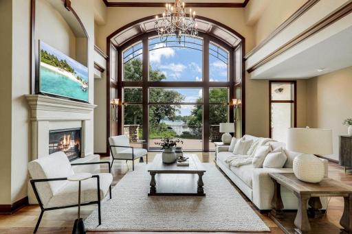 The living room is mostly open to the kitchen and dining room, features a gas fireplace and a magnificent, arched picture window which invites natural light to fill the space.