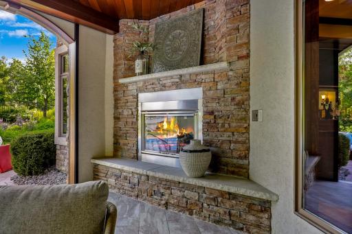 Just off the pool is a patio that was converted by the current owners to an indoor/outdoor cabana space, featuring motorized Phantom screens, a retractable TV and an outdoor gas fireplace.