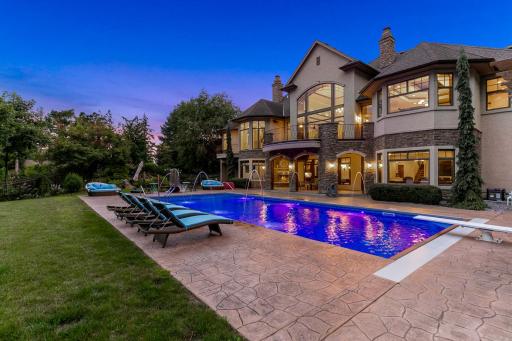 Stamped concrete encircles the pool area, and the private, mostly flat and fully fenced back yard provides ample space for yard games and outdoor relaxation.