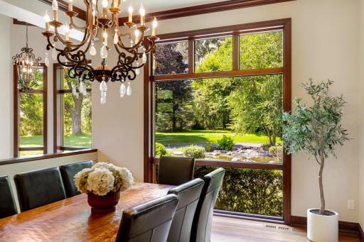 Elegant columns surround the formal dining room which is open and bright with a large picture window.