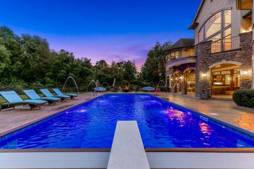 Stamped concrete encircles the pool area, and the private, mostly flat and fully fenced back yard provides ample space for yard games and outdoor relaxation.