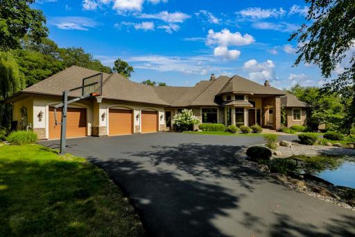 The loop driveway allows for easy flow to and from the property, plenty of room to park guests, and a flat, sport court area with a basketball hoop.