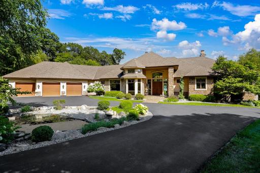 The loop driveway allows for easy flow to and from the property, plenty of room to park guests, and a flat, sport court area with a basketball hoop.