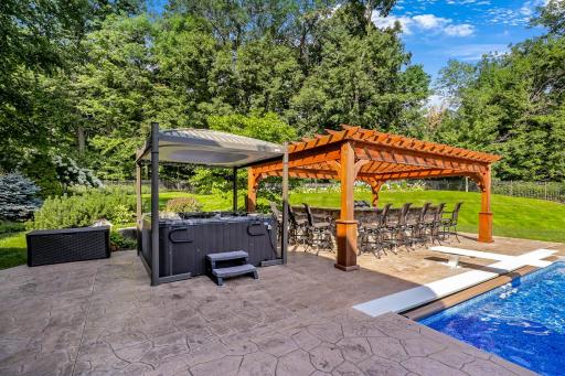 The hot tub features a motorized cover.