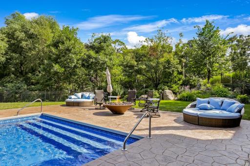 Significant capital was invested into the exterior and landscaping, including a fully equipped outdoor kitchen, a hot tub with a motorized cover, an inground pool with a diving board and water features.