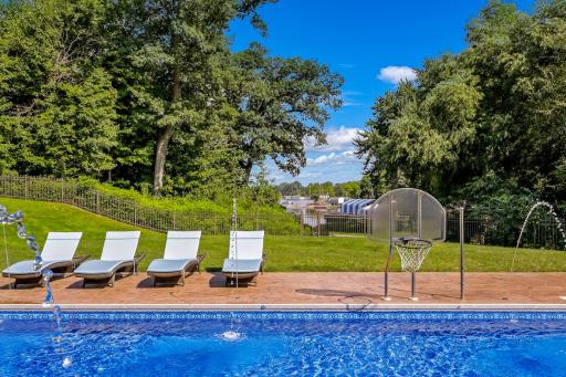 Significant capital was invested into the exterior and landscaping, including a fully equipped outdoor kitchen, a hot tub with a motorized cover, an inground pool with a diving board and water features.