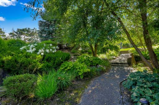 The grounds include numerous additional features, including a wi-fi controlled irrigation system, boulder retaining walls, and perfectly manicured plant life.