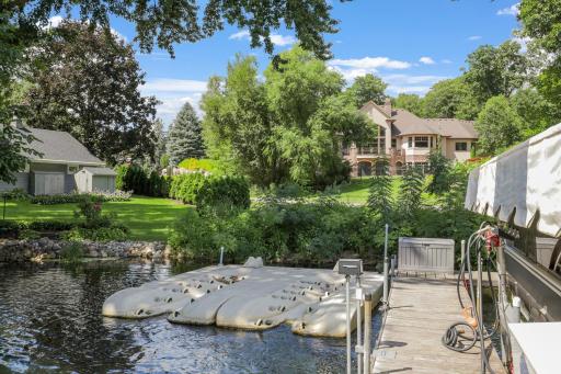 Dock features include electricity, a convenient gas pump system, dual floating jet ski slips, and two Aqua Thruster weed control systems.