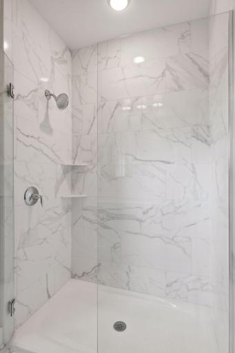 Glass and tile provide a sleek backdrop to the walk-in shower
