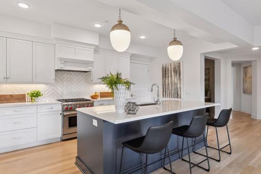 The large center island offers counter seating, perfect for grabbing a quick bite to eat