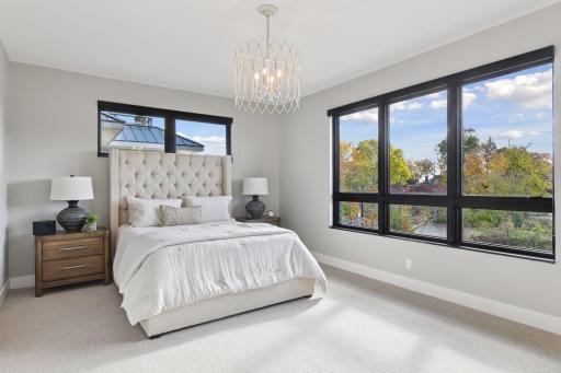 Luxurious primary bedroom overlooking Lake Street