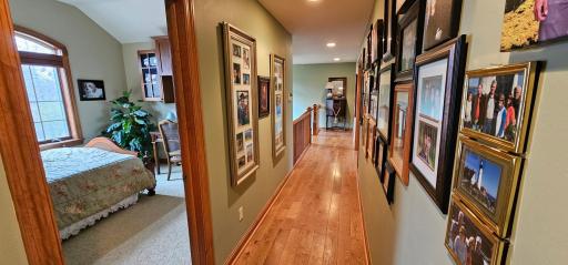 Upper oak hardwood floor hallway with access to both upper bedrooms, upper-level full bath and billiard / craft room.