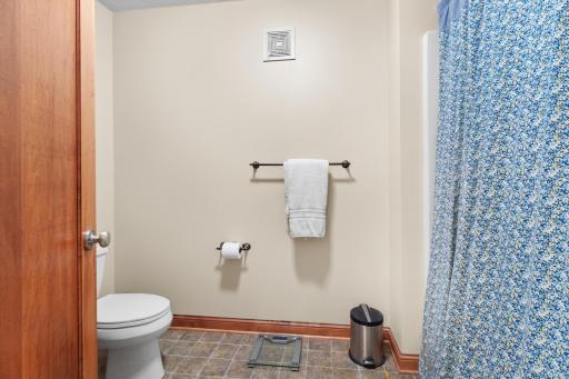 Upper-level full bath WC and tub / shower.