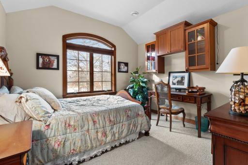 Upper-level second bedroom with view toward front and large natural pond. Walk-in closet.