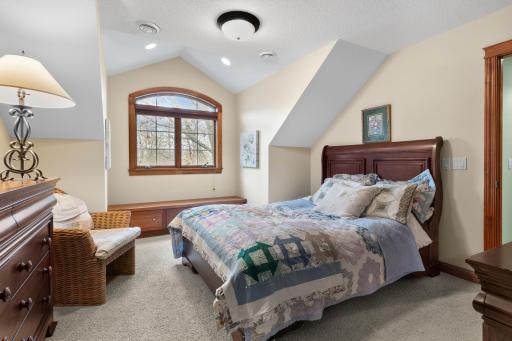 Upper-level first bedroom with view to front yard and large natural pond. Walk-in closet.