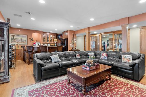 Lower-level recreation room viewed looking toward wet bar and exercise room.