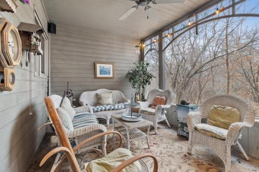 Screened in porch with entry door to main hallway and screen door to garage and driveway area. Speakers part of whole house audio.