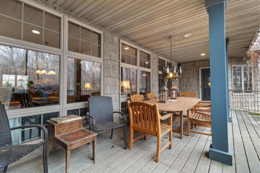 Full length covered patio with Trex-like flooring and view to backyard, and stairs to lower patio, spa and rod iron fenced area. Speakers connected to whole house audio.