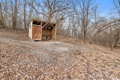 Fenced horse paddock of approximately one acre. With run-in with tack closet and steel roof.