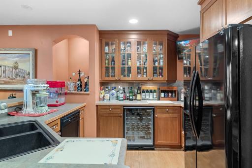 Lower-level recreation room wet bar. Sink, Garbage disposal, dishwasher, wine refrigerator, refrigerator/freezer with icemaker, microwave